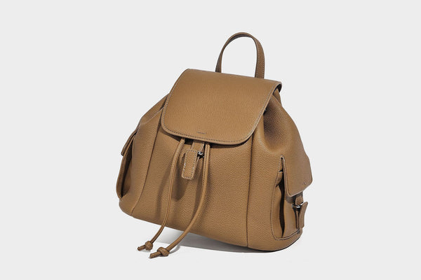 Compact pebbled leather-look flap drawstring backpack handbag with side pockets, top handle, and silver-tone hardware, detail