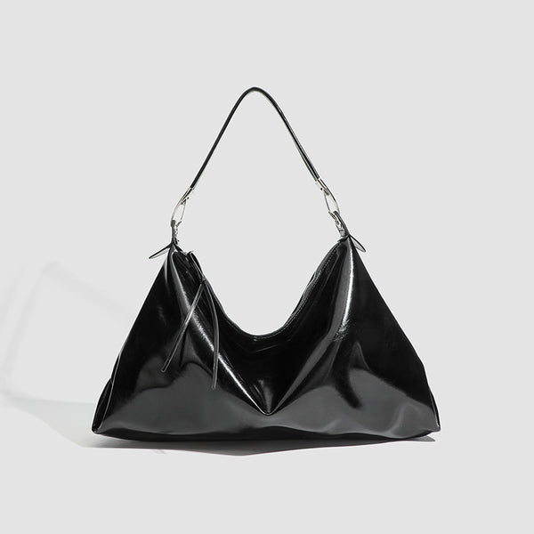Glossy structured shoulder tote bag with silver-tone hardware and top zip closure, front view