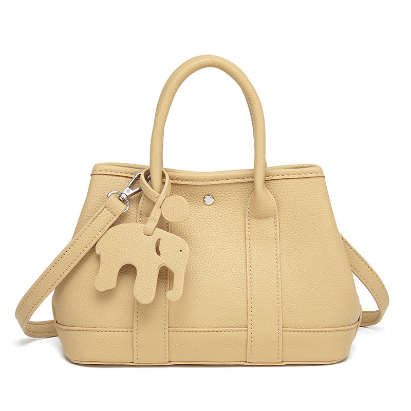 Structured pebbled leather-look top-handle tote bag with elephant charm and detachable shoulder strap, detail view 8