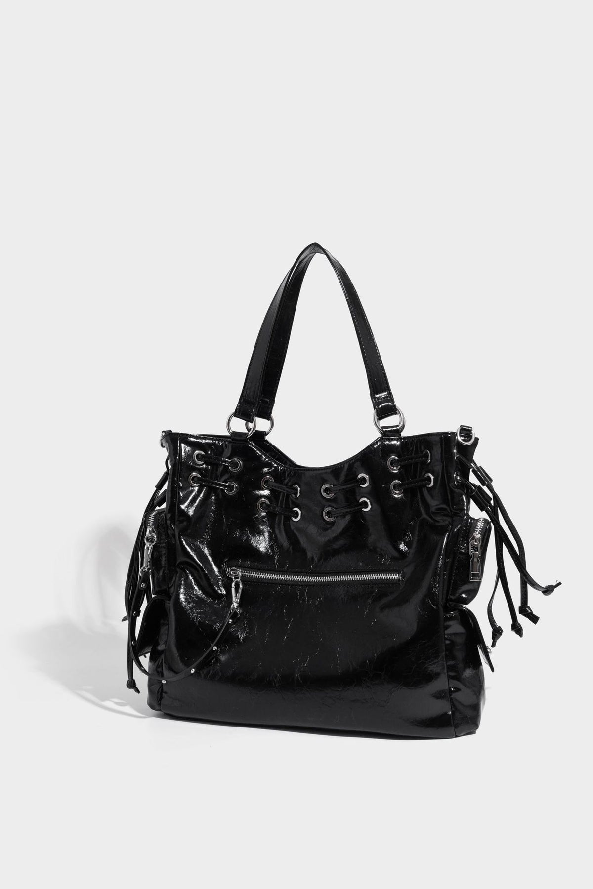 Glossy crinkled leather-look tote bag with silver grommet lace-up front detail, dual top handles, and detachable shoulder