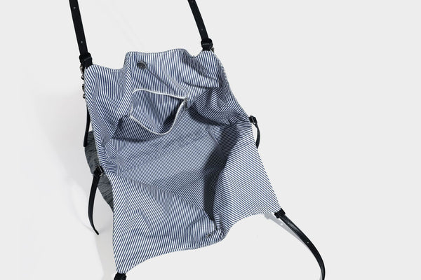 Large slouchy woven-texture shoulder tote bag with slim leather-look straps, side cinch ties, and silver-tone hardware