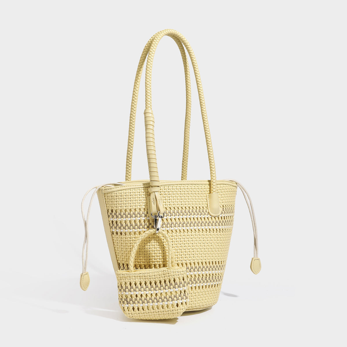 Light blue open-weave woven bucket tote bag with long braided shoulder straps, drawstring side ties, and attached mini pouch