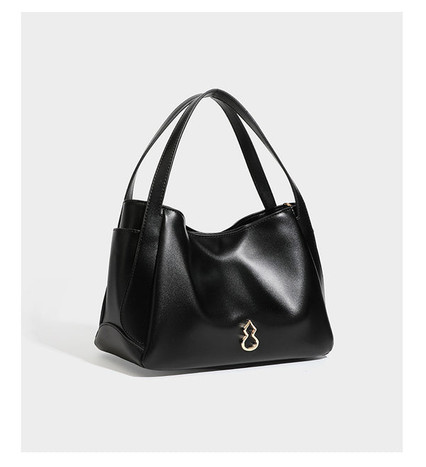 Structured glossy leather-look tote shoulder bag with dual top handles, detachable crossbody strap, side pockets, and, detail