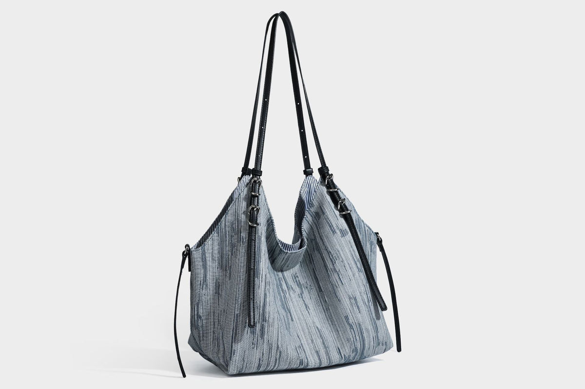 Large slouchy woven-texture shoulder tote bag with slim leather-look straps, side cinch ties, and silver-tone hardware