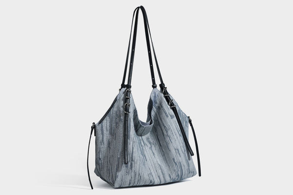 Large slouchy woven-texture shoulder tote bag with slim leather-look straps, side cinch ties, and silver-tone hardware