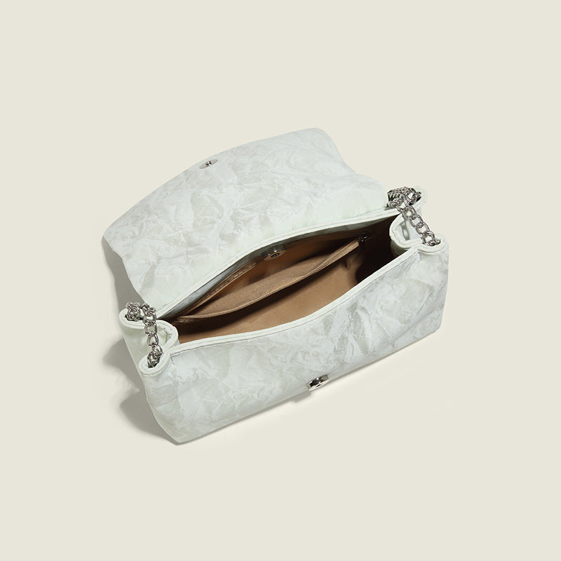 Structured rectangular chain shoulder bag with silver butterfly clasp and glossy crinkled finish, detail view 4
