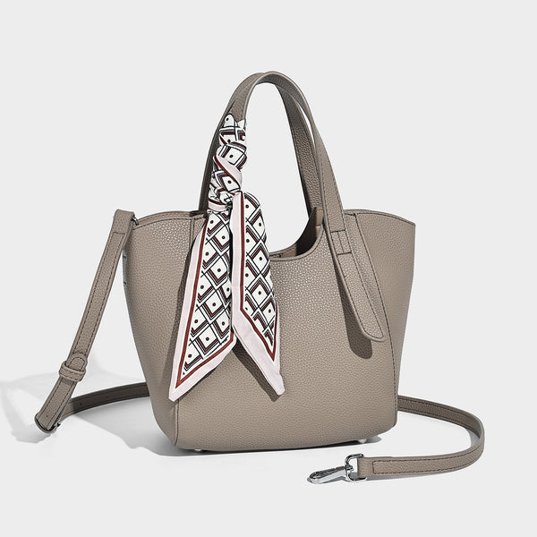 Structured pebbled leather-look tote bag with detachable scarf tie, dual top handles, and adjustable crossbody strap, detail