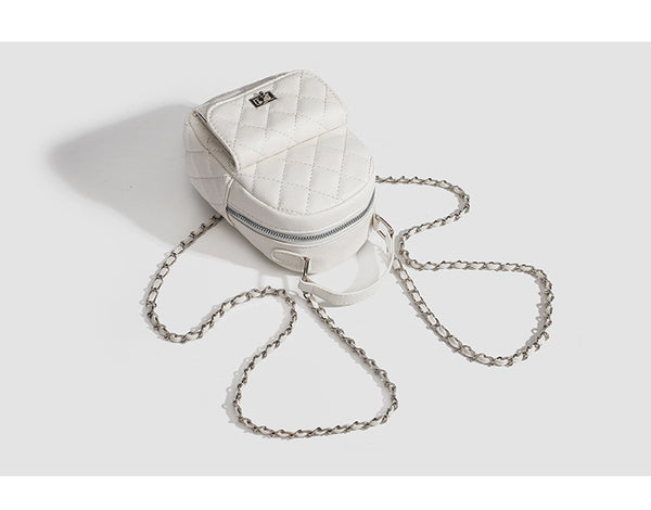 Compact diamond-quilted mini backpack handbag with silver-tone chain straps and turn-lock front pocket, detail view 8