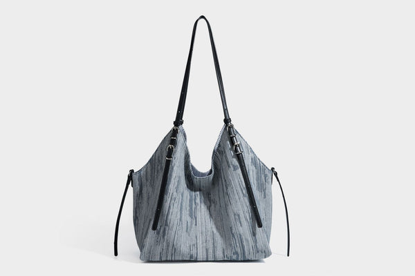 Large slouchy woven-texture shoulder tote bag with slim leather-look straps, side cinch ties, and silver-tone hardware