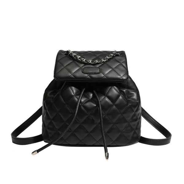 Black diamond-quilted backpack handbag with silver-tone chain flap accent and adjustable shoulder straps, detail view 5