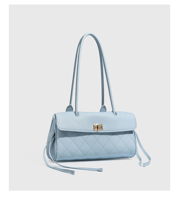 Structured black diamond-quilted shoulder bag with gold-tone turn-lock flap closure and dual round shoulder straps, detail