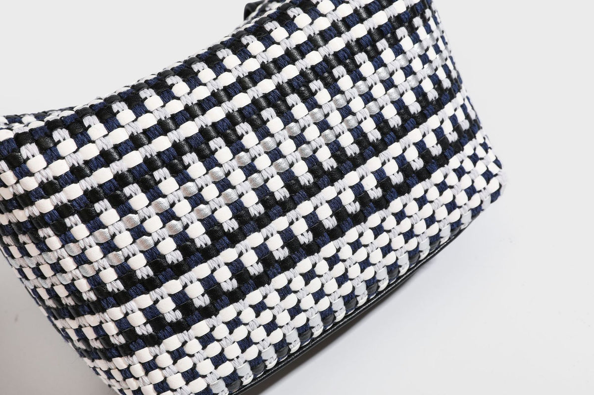 Small crescent shoulder bag in black-and-white woven textile with smooth black leather-look trim, zip-top closure, knotted
