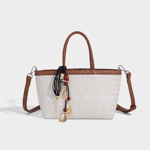 Structured chevron woven leather-look tote bag with braided top handles, gold feather charm, and adjustable shoulder strap