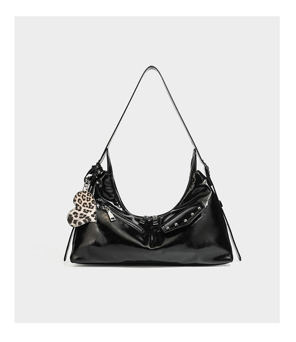 Glossy dark brown hobo shoulder bag with slim strap, front zip pocket, stud detail, and detachable leopard-print heart charm