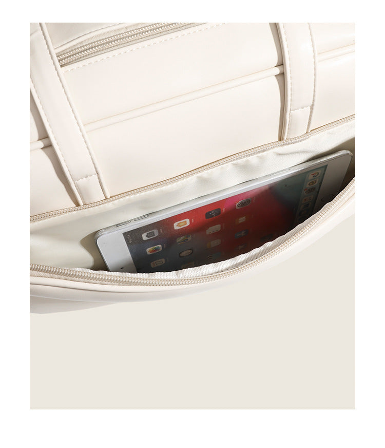Large structured rectangular leather-look shoulder bag with dual zip compartments and double top handles, detail view 10