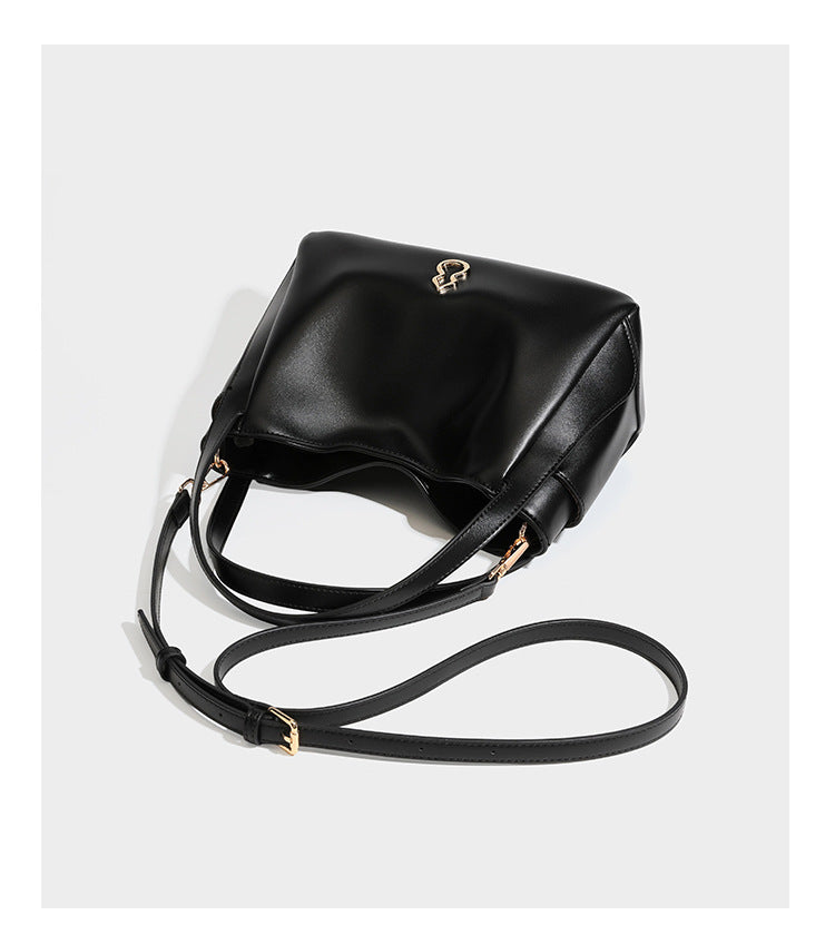 Structured glossy leather-look tote shoulder bag with dual top handles, detachable crossbody strap, side pockets, and, detail