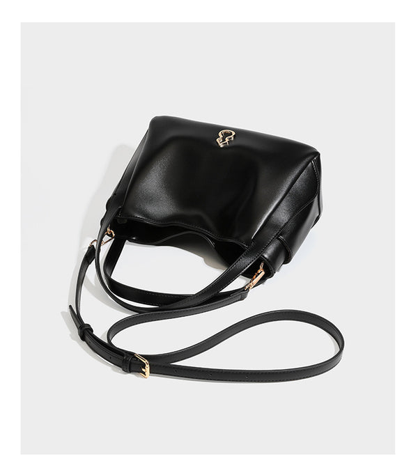 Structured glossy leather-look tote shoulder bag with dual top handles, detachable crossbody strap, side pockets, and, detail