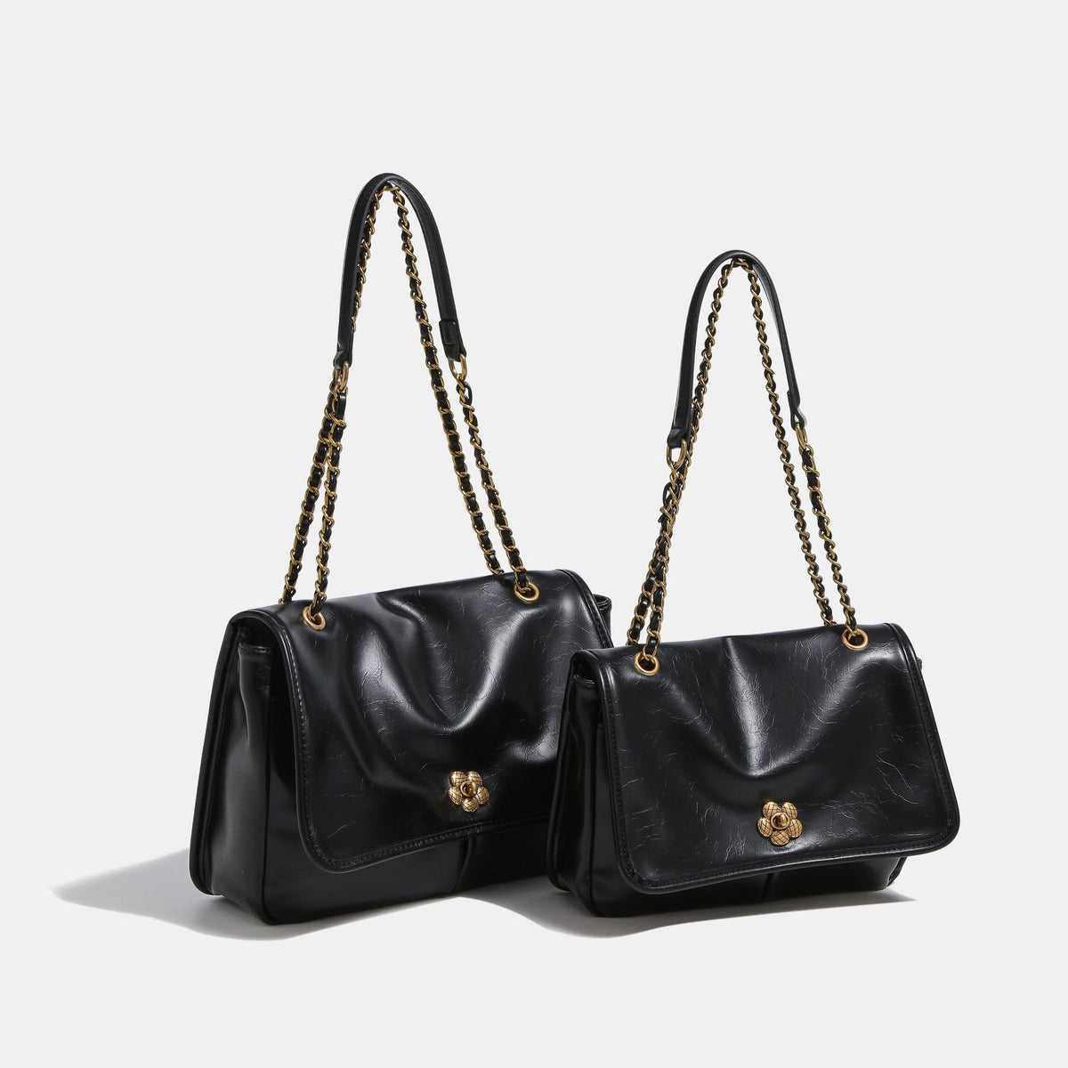 Structured flap shoulder bag with antique gold-tone chain strap and flower turn-lock clasp in crinkled leather-look finish
