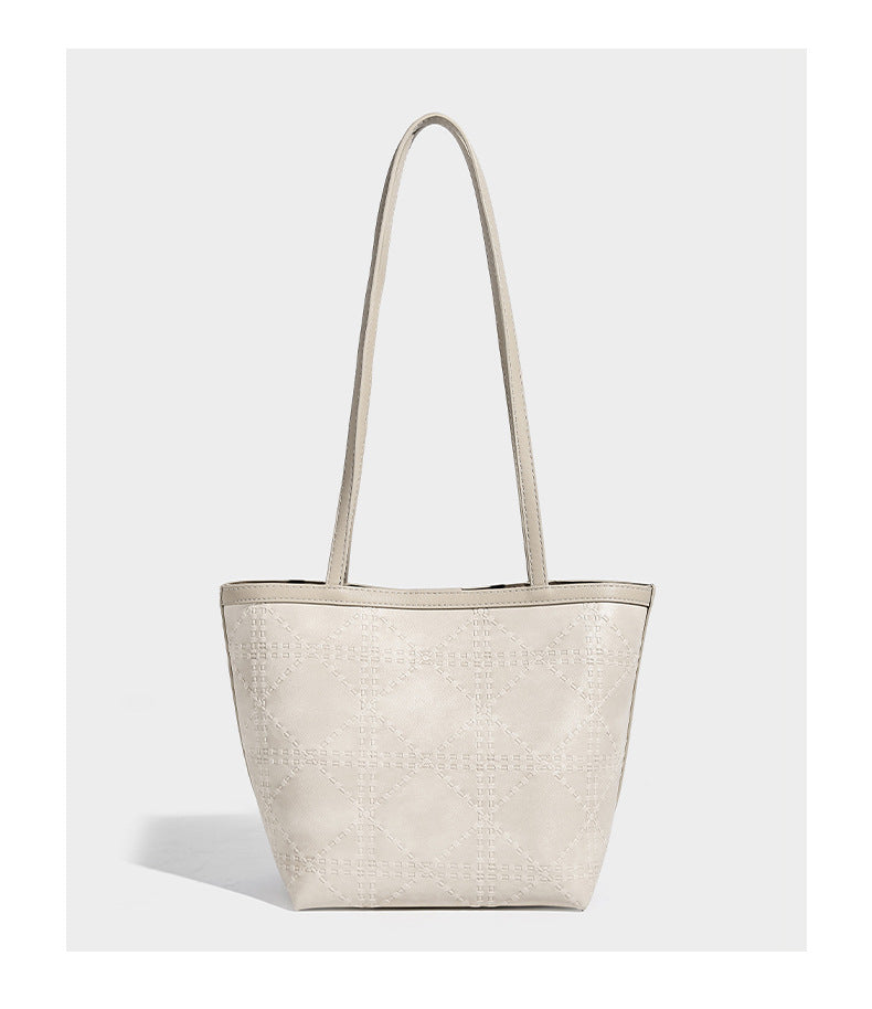 Quilted diamond-pattern tote bag with attached front zip pouch and long shoulder straps, detail view 10