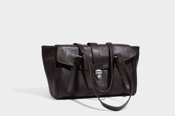 Large structured vintage-style tote bag with flap-front turn-lock closure, twin buckle straps, and double shoulder handles