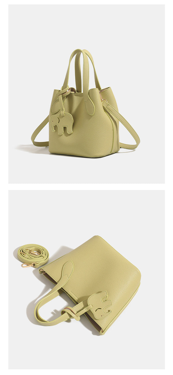 Pebbled leather-look bucket tote with elephant charm pendant, dual top handles, and detachable shoulder strap, detail view 12