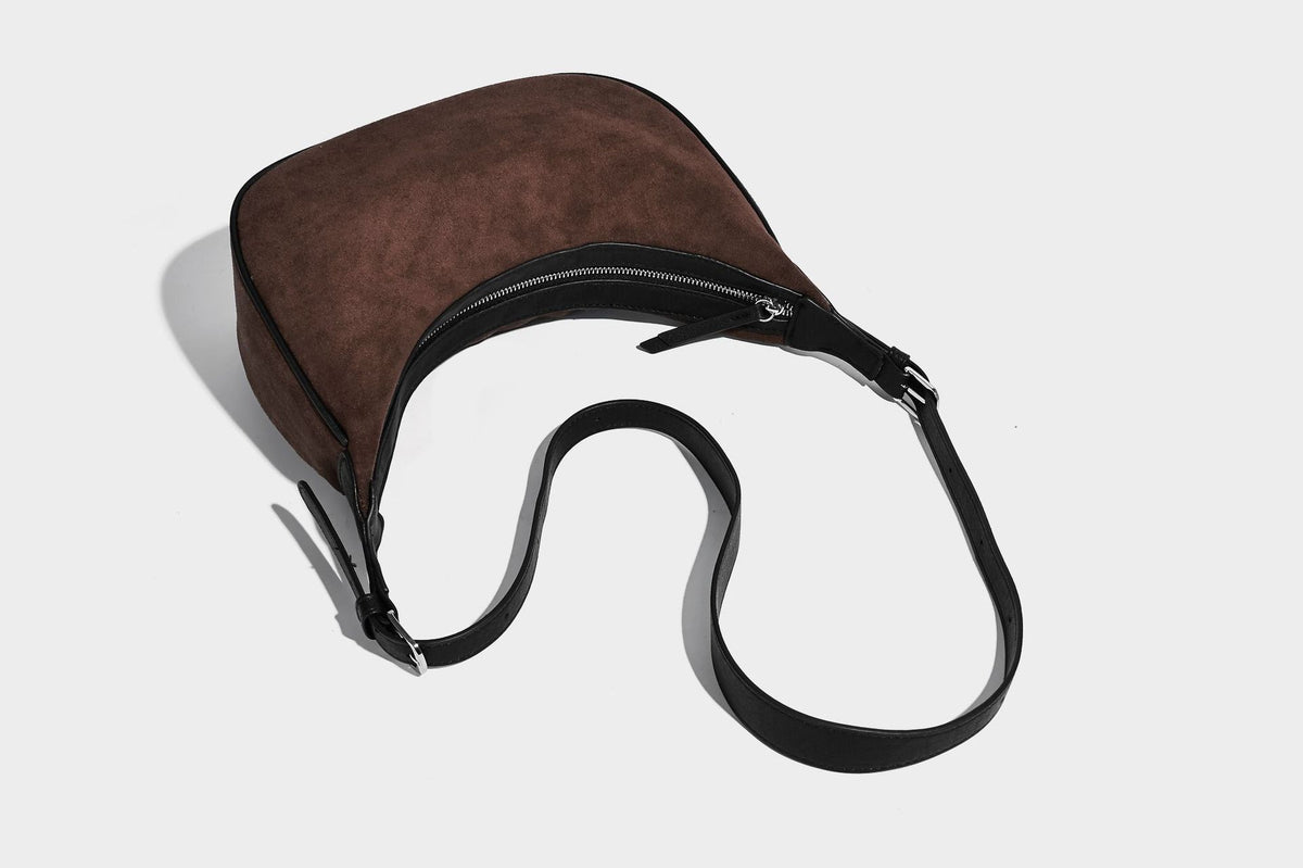 Crescent hobo shoulder bag in matte suede-look finish with black trim and adjustable strap, detail view 18
