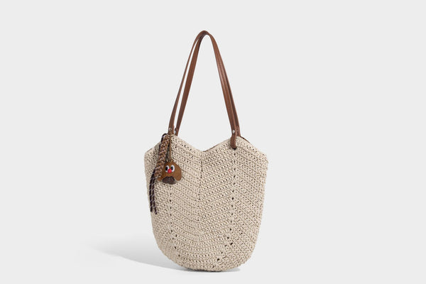 Woven crochet open-top shoulder tote bag with slim brown leather-look straps and braided charm accent, detail view 7