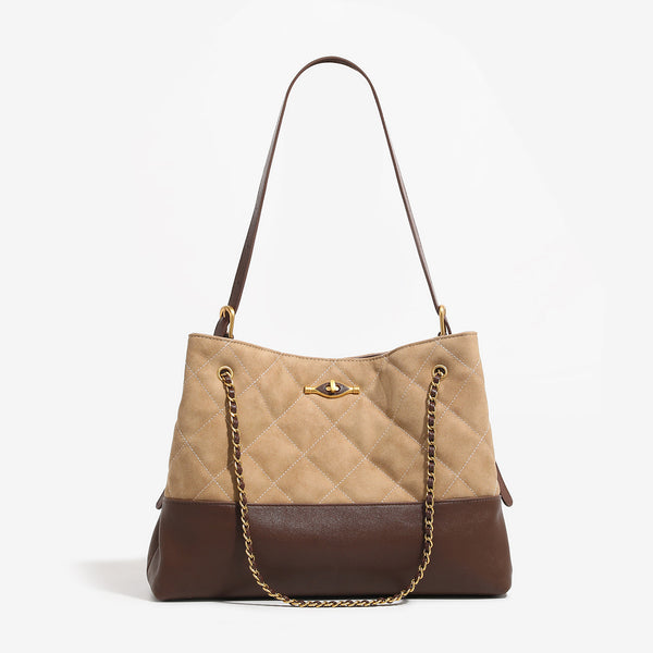Large quilted two-tone shoulder tote bag with gold-tone chain handles and eye-shaped clasp hardware, detail view 7