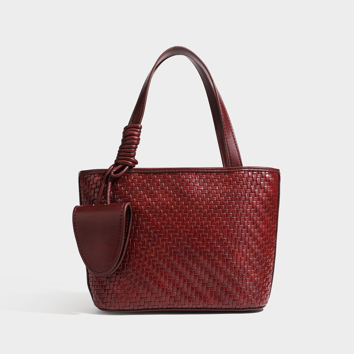 Strukturierte Tote-Bag mit Webstruktur in Braun und goldfarbenen Beschlägen, mit Seil umwickelten Tragegriffen, kleiner Fronttasche sowie, Detailansicht
