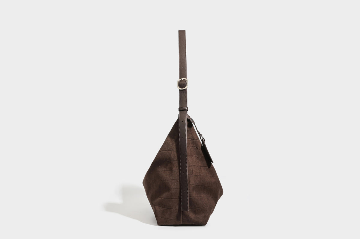 Slouchy hobo shoulder bag in matte croc-embossed leather-look finish with top zip closure and long adjustable strap, detail