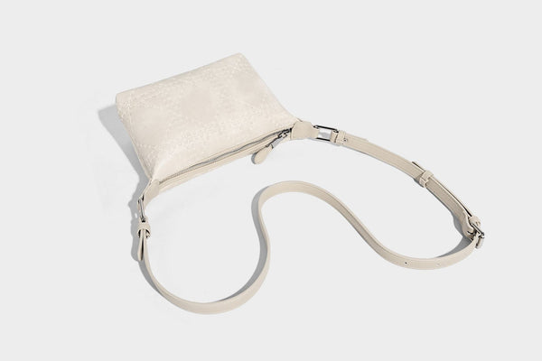 Small embossed half-moon shoulder bag with top zipper, detachable front pouch, and adjustable slim strap, detail view 19