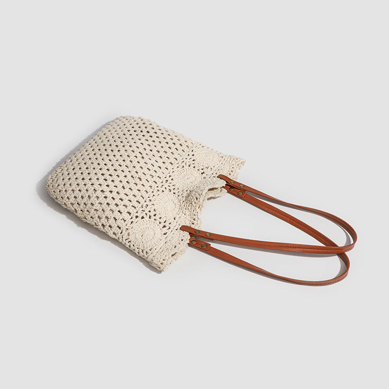 Woven crochet shoulder tote bag with scalloped floral top edge, tan leather-look straps, and antique gold rivets, detail view