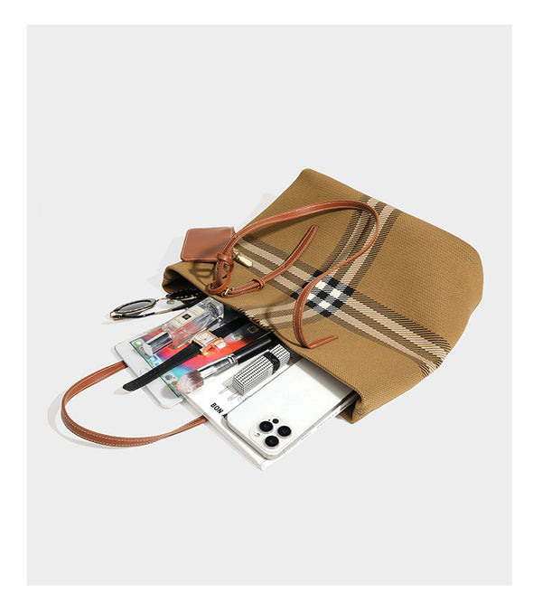 Large structured plaid check tote bag with smooth tan leather-look shoulder straps, attached front zip pouch, and gold-tone