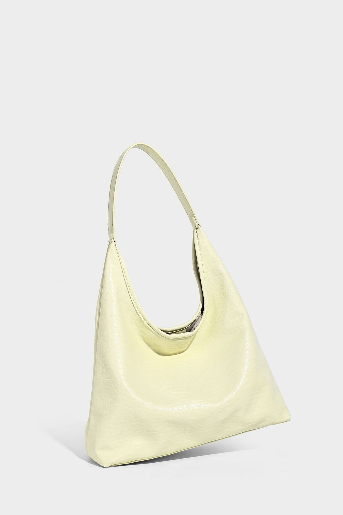 Slouchy hobo shoulder bag in pale yellow glossy pebbled leather-look finish with single shoulder strap and detachable front