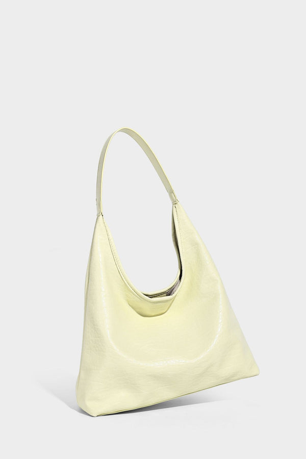 Slouchy hobo shoulder bag in pale yellow glossy pebbled leather-look finish with single shoulder strap and detachable front