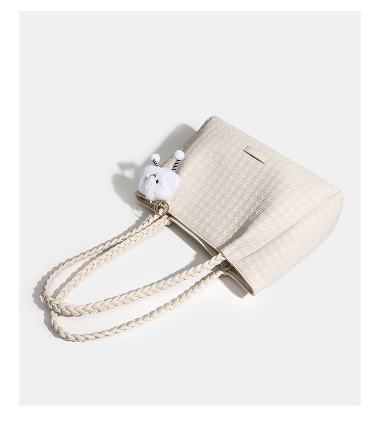 Structured geometric-embossed tote bag with braided shoulder straps and gold-tone hardware in ivory, detail view 9