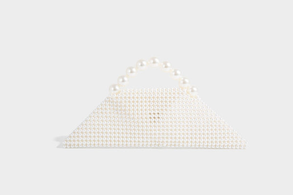 Small structured triangle clutch bag covered in glossy pearl beads with an arched pearl top handle and silver snap closure