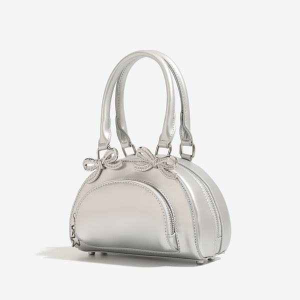 Structured half-moon mini handbag with silver-tone crystal bow hardware and star charm chain, detail view 3