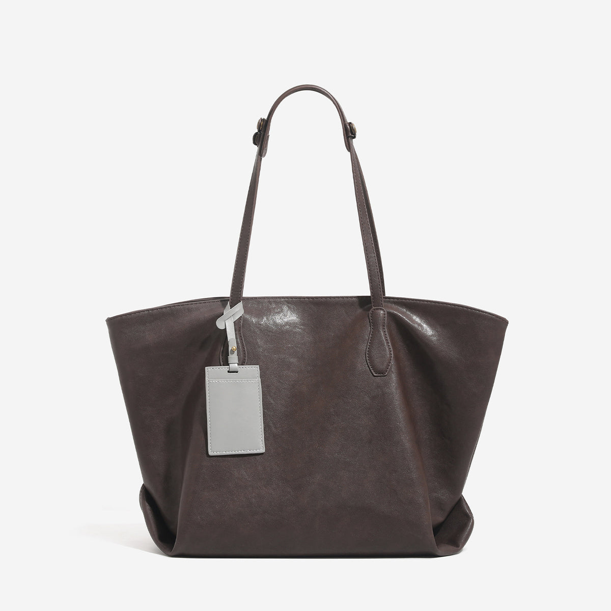 Large leather-look tote bag with trapezoid silhouette, double shoulder straps, and detachable hanging tag, detail view 7