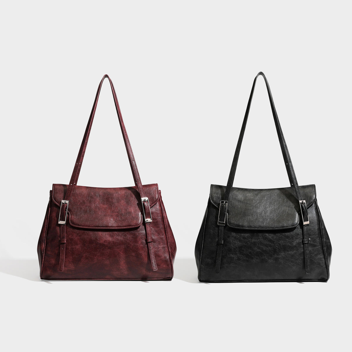 Structured flap-top shoulder tote bag in distressed leather-look finish with silver-tone buckle hardware and double shoulder
