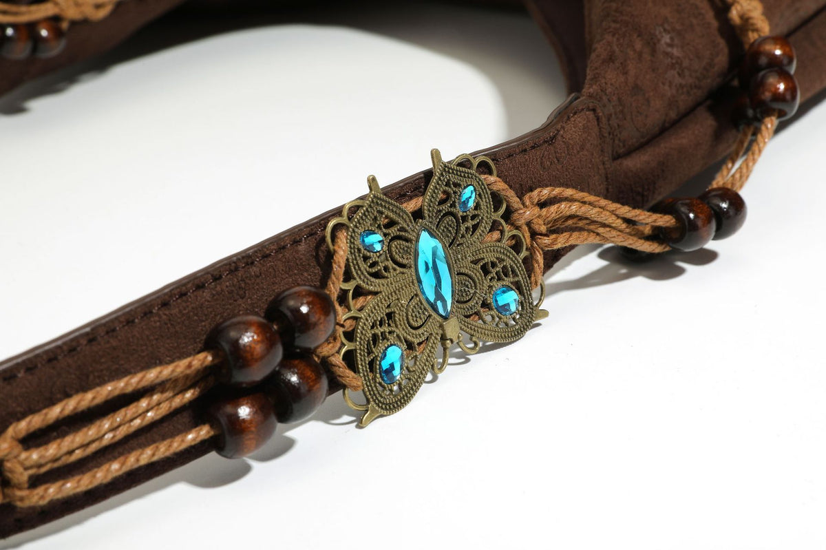 Slouchy boho hobo shoulder bag in embossed brown suede-look finish with beaded strap, cord tassels, and brass-tone leaf