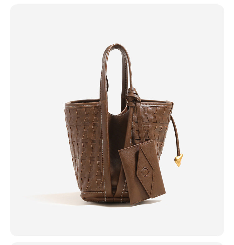 Woven embossed leather-look bucket bag with triangular texture pattern, gold-tone hardware, and attached mini snap pouch