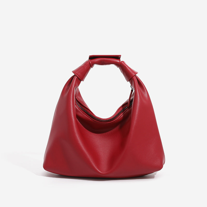 Slouchy leather-look hobo bag with knotted loop handle and top zipper closure, detail view 8