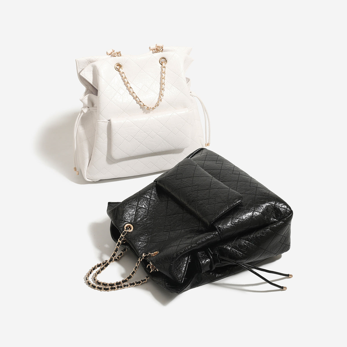 Large quilted leather-look drawstring backpack handbag with gold-tone chain handles and front flap pocket, front view