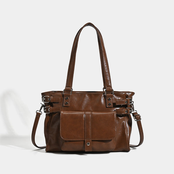 Large glossy leather-look tote bag with front flap pocket, silver-tone buckle hardware, dual top handles and detachable