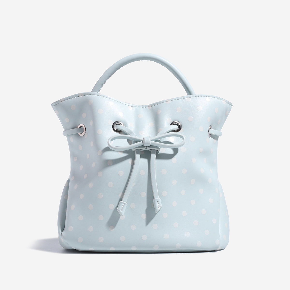 Cream white polka-dot drawstring bucket bag with black leather-look top handle and bow-tied cord closure, detail view 6