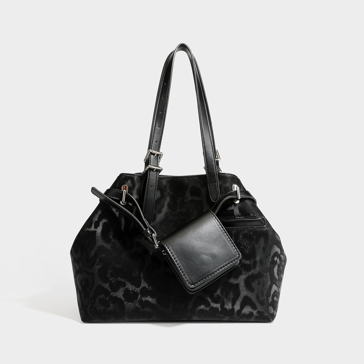 Glossy leopard-print tote bag with leather-look dark trim, dual top handles, detachable shoulder strap, and attached front