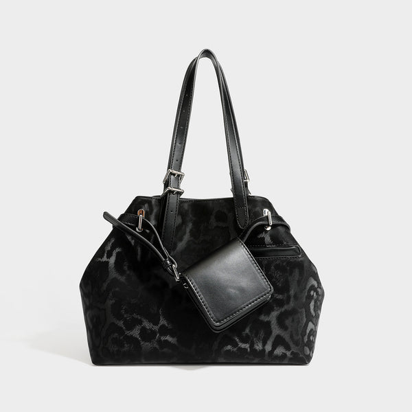 Glossy leopard-print tote bag with leather-look dark trim, dual top handles, detachable shoulder strap, and attached front