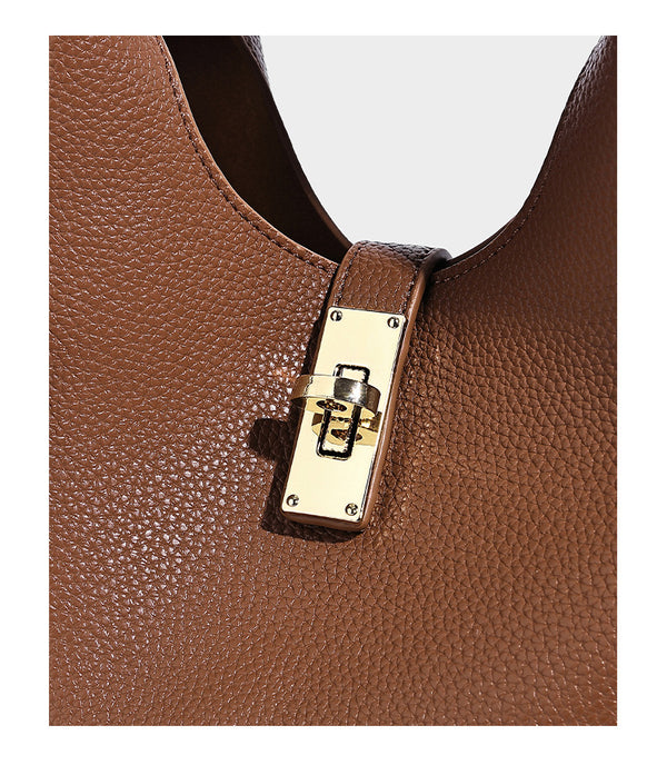 Structured pebbled-texture bucket bag with arched top handles, gold-tone turn-lock closure, and detachable shoulder strap