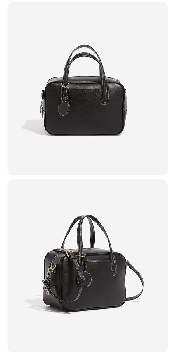 Structured boxy bowling-style tote bag in deep brown leather-look finish with dual top handles, front slip pocket, round